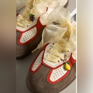 Anthropologie 
Shoe accessories 
Yellow shoe laces with fruit charms.